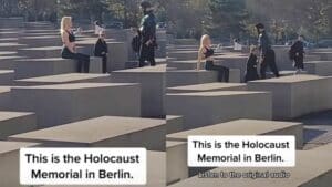 A woman in black athletic wear sitting on a concrete block at the Holocaust Memorial in Berlin.
