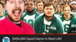 Group of people wearing green and white Squid Game costumes with one man in a red jacket excitedly taking a selfie