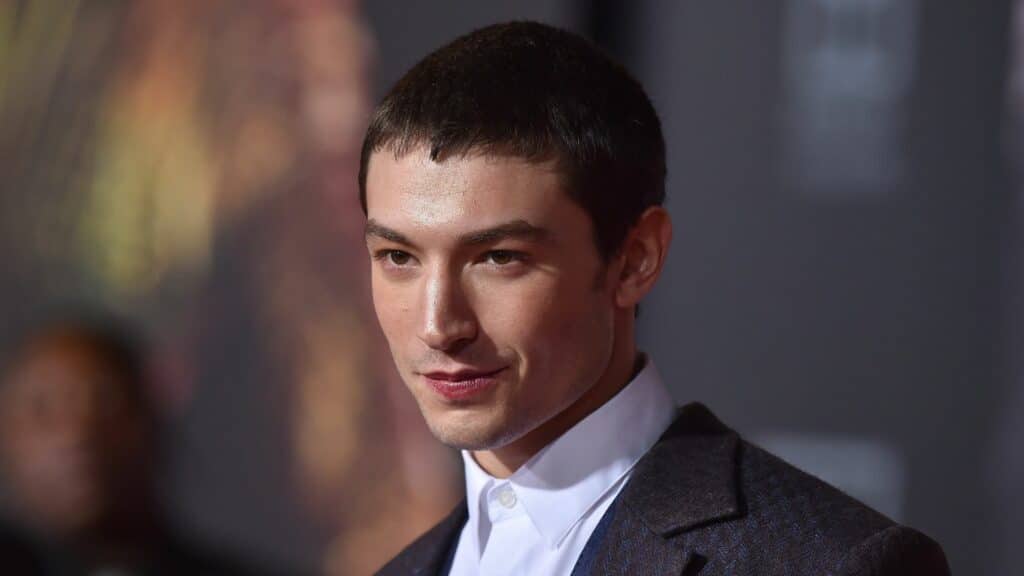 Actor Austin Butler wearing a dark suit and white shirt at a formal event.