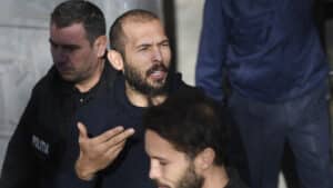 Former kickboxer Andrew Tate and his brother Tristan (not seen) leave court with police cars after their trial in Bucharest, Romania on February 01, 2023.