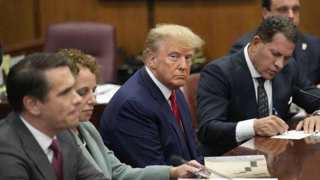 Former U.S. President Donald Trump sits at the defense table with his defense team in a Manhattan court during his arraignment on April 4, 2023, in New York City. Trump was arraigned during his first court appearance today following an indictment by a grand jury that heard evidence about money paid to adult film star Stormy Daniels before the 2016 presidential election. With the indictment, Trump becomes the first former U.S. president in history to be charged with a criminal offense.