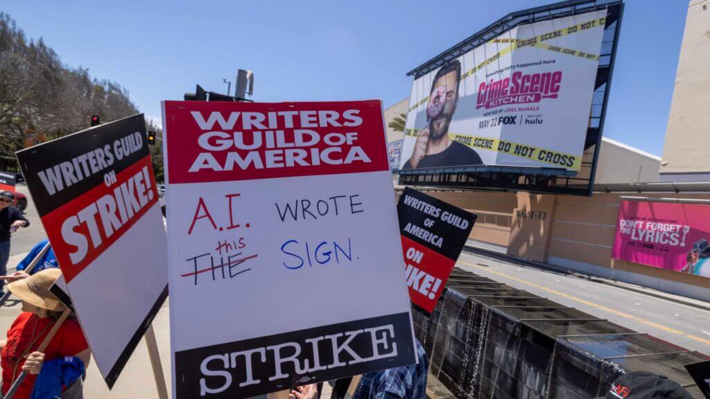 LOS ANGELES, CA - MAY 02: People picket outside of FOX Studios on the first day of the Hollywood writers strike on May 2, 2023 in Los Angeles. Scripted TV series, late-night talk shows, film and streaming productions are being interrupted by the Writers Guild of America (WGA) strike. In 2007 and 2008, a WGA strike shut down Hollywood productions for 100 days, costing the local economy between $2 billion and $3 billion.