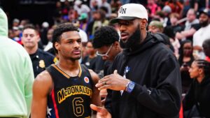 Bronny James #6 of the West team talks to Lebron James of the Los Angeles Lakers after the 2023 McDonald's High School Boys All-American Game at Toyota Center on March 28, 2023 in Houston, Texas.