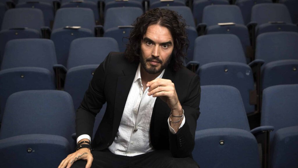 Russell Brand poses for photographs as he arrives to deliver The Reading Agency Lecture at The Institute of Education on November 25, 2014 in London, England. Russell Brand will deliver 'a manifesto on reading' which will be in part personal, sharing his own experience of books and reading while growing up in the UK.