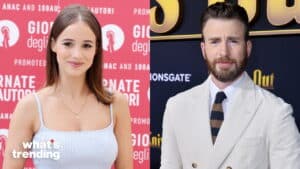 Young woman in white dress at event and man in white suit with striped tie at premiere backdrop