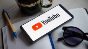 In this photo illustration a YouTube logo seen displayed on a smartphone.
