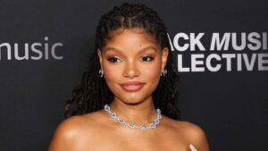 Chloe Bailey with braided hair and a silver necklace at the Black Music Collective event.