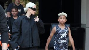 Reality TV star Kim Kardashian showcases her blonde hair as she exits a basketball game with her son Saint West in Los Angeles.