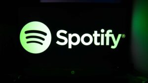 The Spotify logo is being displayed on a laptop screen with a glowing keyboard in Krakow, Poland, on March 3, 2024.