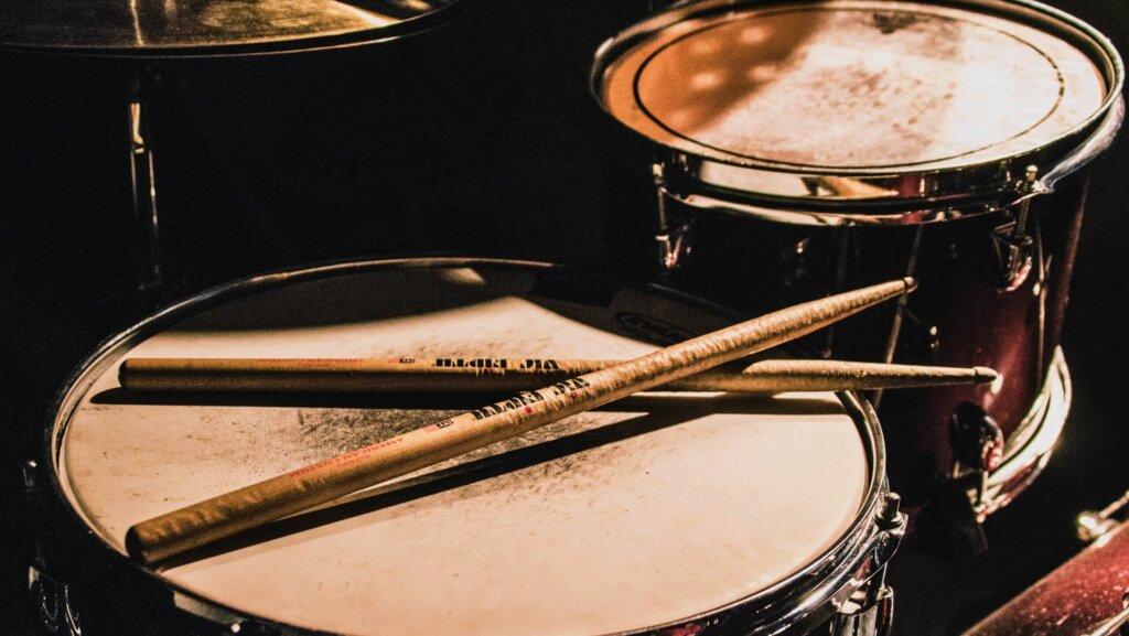 Drums are percussion instruments which set the beats, and that create the rhythm in music.