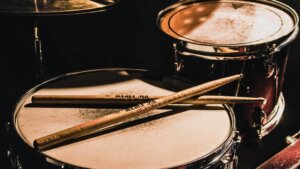 Drums are percussion instruments which set the beats, and that create the rhythm in music.