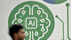 Blurred person walking past a green AI chip and brain circuit illustration on a white wall