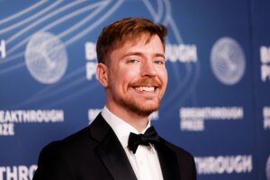 Man in black tuxedo and bow tie smiling at Breakthrough Prize event