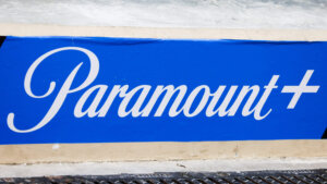 Paramount+ logo in white script on a blue background painted on a wall.