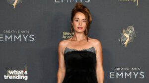 Woman in a black strapless dress posing at the Creative Arts Emmys event backdrop